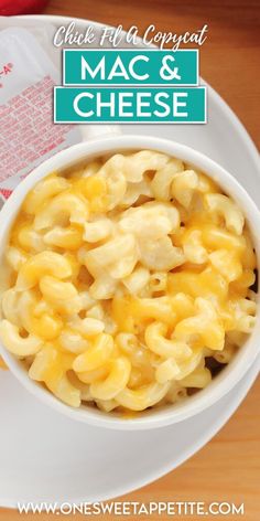 macaroni and cheese in a white bowl on top of a wooden table next to a bag of macaroni and cheese