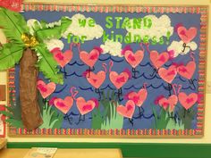 we stand in the kindness bulletin board with pink flamingos and palm trees on it