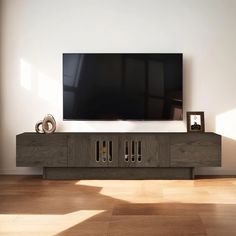 a flat screen tv sitting on top of a wooden entertainment center