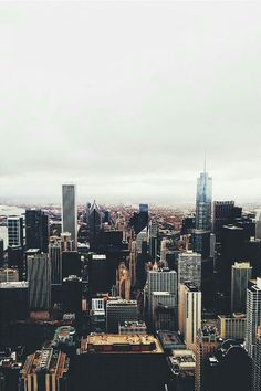 an aerial view of a city with skyscrapers and other tall buildings in the background