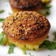 some food is sitting on a white plate with green garnish and sprinkles