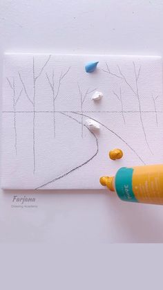 someone is drawing trees on a piece of paper with crayons and marker pens