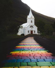 a rainbow painted walkway leading to a white church