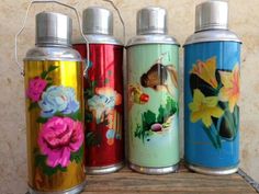 four colorful flasks with flowers painted on them