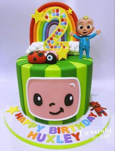 a birthday cake for a one year old with an image of a cartoon character on top