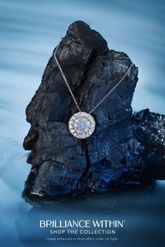 the bridalnce within necklace is displayed on top of a rock in the water