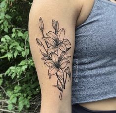 a woman's arm with a flower tattoo on the left side of her arm