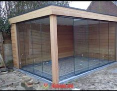 a wooden structure with glass walls in the middle