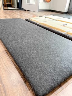 a large gray rug on the floor in front of a door