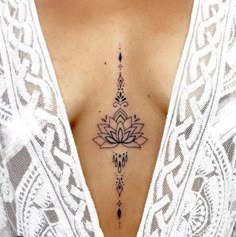 a woman's chest with a tattoo design on the top and bottom part of her stomach