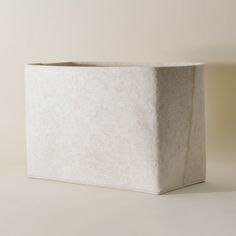 a square white box sitting on top of a table