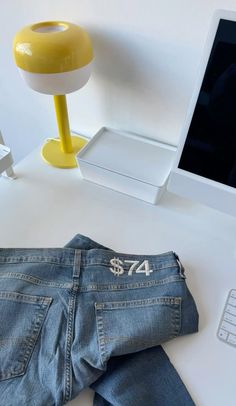 a pair of jeans sitting on top of a white desk