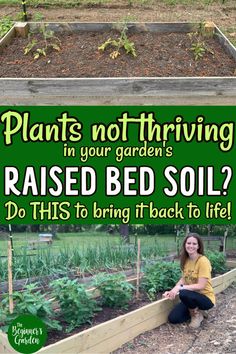 a woman sitting on the ground in front of a raised bed garden with plants growing