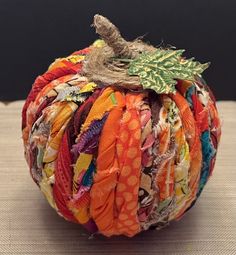 a decorative pumpkin made out of fabric scraps