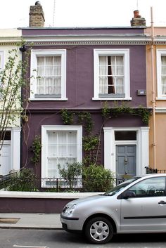 a car parked in front of a row of houses