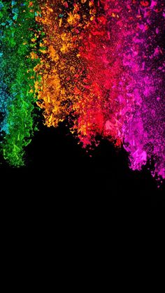 an image of colorful powder in the dark