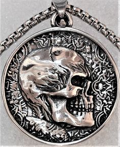 Double Sided Skull Pendant with 23 inch Necklace, Can be worn on either side of designs. One Double Faced Pendant 1.25 inches and One 23 inch chain comes with your order. Nickel-free Stainless Steel Skull Necklace, Skull-shaped Engraved Stainless Steel Necklace, Skull Shaped Engraved Stainless Steel Necklace, Engraved Skull Necklace In Stainless Steel, Symbolic Skull Jewelry With Oxidized Finish, Collectible Silver Skull Necklace, Hollywood Fl, Urn Necklace, Gothic Necklace