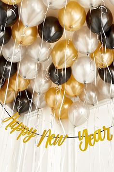 a bunch of balloons that say happy new year