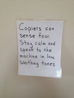 a note taped to the wall with words written on it