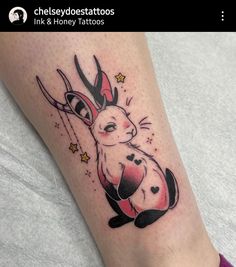 a rabbit tattoo on the leg with scissors