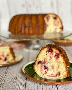 a piece of cake on a plate with another slice in the background