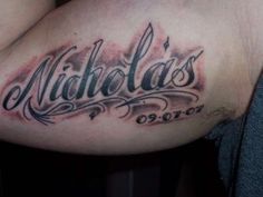 a close up of a person's arm with tattoos on it and the word nicholas written in cursive writing