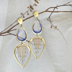 These Water Dew Drops Transparent Blue Resin Earrings are a delicate and elegant accessory, perfect for adding a touch of serenity to any look. The design features teardrop-shaped transparent blue resin pieces that evoke the purity of water droplets. Below, the open heart-shaped frame adorned with tiny golden chains and beads enhances the illusion of glistening dew. These earrings beautifully capture the essence of a fresh morning dew and are sure to charm those who appreciate nature-inspired jewelry.  The earrings dangle gracefully from gold-plated hooks, ensuring they are lightweight and comfortable for all-day wear. Whether you're dressing up for a special occasion or adding a unique flair to your everyday outfit, these resin earrings are sure to draw compliments and spark conversations Work Earrings, Fresh Morning, Resin Work, Heart Shaped Frame, Morning Dew, Dew Drops, Nature Inspired Jewelry, Water Droplets, Resin Earrings