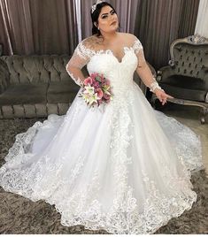 a woman in a wedding dress posing for the camera