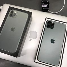 two iphones sitting next to each other on top of a white table with an apple watch