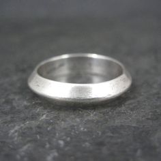 This beautiful, vintage band ring is sterling silver. Measurements: 4mm wide Size: 6 Marks: Tribal, Sterling Condition: Excellent Classic Sterling Silver Wide Band, Silver Dome Ring For Wedding With Round Band, Classic 925 Stamped Toe Rings, Classic Stamped 925 Toe Rings, Classic Toe Ring Stamped 925, Classic Hallmarked Toe Rings, Silver Stackable Dome Ring For Wedding, Heirloom Silver Ring With Thick Band, Classic Untreated Promise Ring