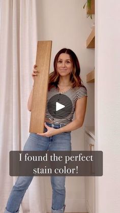 a woman holding a wooden board in her hands and the caption reads, i found the perfect stain color