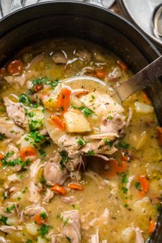 a ladle full of chicken and potato soup