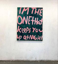 a sign that says i'm the one that keeps you up at night on a wall