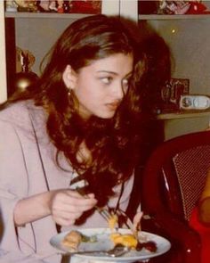 a woman sitting at a table eating food