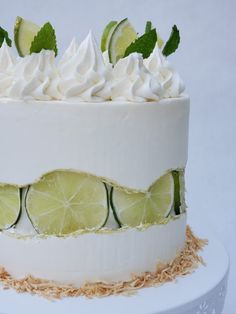 a white cake with lime slices and whipped cream