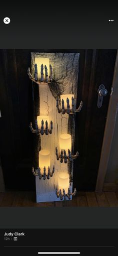 a bunch of candles that are on a wall