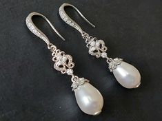 Wedding White Teardrop Pearl Silver Chandelier Bridal Statement Earrings. PLEASE READ ITEM DESCRIPTION and SHOP POLICIES before placing your order, and contact me with any questions! EARRINGS are about 1.57 inch (4cm) long from top of earring hook to bottom. BRIDAL EARRINGS SECTION: https://www.etsy.com/shop/LanaChayka?ref=seller-platform-mcnav§ion_id=11638940 BRIDAL JEWELRY SETS SECTION: https://www.etsy.com/shop/LanaChayka?ref=seller-platform-mcnav§ion_id=25839214 BRIDAL NECKLACES SECTION: htt White Elegant Teardrop Dangle Earrings, White Elegant Dangle Teardrop Earrings, White Dangle Teardrop Earrings With Elegant Design, Classic White Drop Chandelier Earrings, Wedding Bridal Drop Earrings With Ear Wire, Wedding Drop Bridal Earrings With Ear Wire, Teardrop Bridal Earrings With Ear Wire For Wedding, Classic Wedding Teardrop Earrings, Classic Teardrop Earrings For Wedding