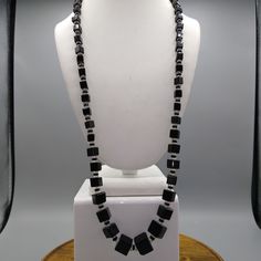 "Vintage Faceted French Jet Cube Necklace, Unique Art Deco Graduated Geometric Black Glass Beads form Long Infinity Strand Graduated cube beads are crisp cut and beveled. They are strung and have both clear and black smaller faceted crystal spacers. No clasp, opera length. Classy 20s flapper fashion at it's finest! Measurement * 28\" Condition * Very nice condition, gently worn. Features: * Art Deco Size: Womens 28\" Condition: Pre-Owned Good" Elegant Beaded Glass Crystal Necklace, Black Rectangular Beaded Jewelry, Elegant Glass Beads With Beaded Chain, Glass Beaded Necklaces With Spacer Beads For Party, Glass Beaded Necklaces For Party Costume Jewelry, Party Glass Beaded Necklaces With Spacer Beads, Adjustable Crystal Necklaces With Black Beads For Party, Adjustable Crystal Necklace With Black Beads For Parties, Adjustable Black Beaded Crystal Necklaces For Parties