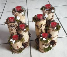 several candles are placed on top of birch logs