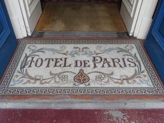 the entrance to hotel de paris is decorated with mosaic tiles