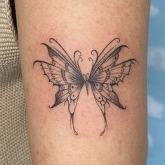 a small butterfly tattoo on the leg