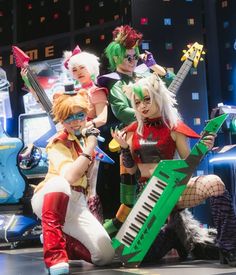 the group of people are dressed up as they play musical instruments and pose for a photo