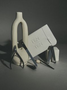 three pairs of scissors and a pair of shears sit next to each other on a gray surface