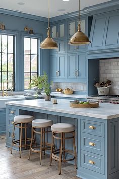 a kitchen with blue cabinets and stools in the middle of the countertop area