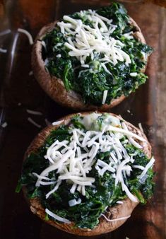 two breads with cheese and spinach on them