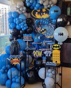 a room filled with balloons and batman decorations