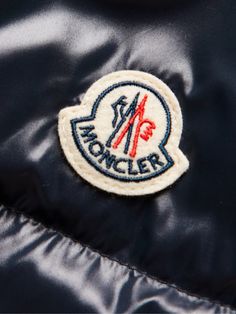 Moncler takes its name from the Alpine town of Monestier-de-Clermont and its collections are always built with those snowy conditions in mind. This 'Coutard' jacket is cut from glossy midnight-blue shell that's quilted and packed with insulating down. The sleeve is appliquéd with the house logo. Small to size. See Size & Fit notes. Hooded Winter Outerwear With Logo Patch, Winter Outdoor Outerwear With Logo Patch, Designer Winter Outerwear With Logo, Designer Winter Outerwear With Logo Detail, Classic Winter Outerwear With Logo, Classic Winter Outerwear With Logo Detail, Blue Winter Outerwear With Logo Patch, Winter Hooded Outerwear With Logo Detail, Hooded Winter Outerwear With Logo Detail