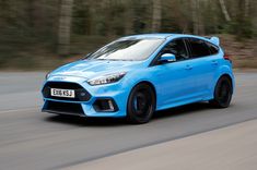 a blue ford focus st driving down the road