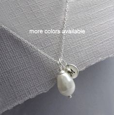 Hand Stamped Initial Charm and Swarovski White Drop Pearl on Sterling Silver Necklace Chain PEARL ALSO AVAILABLE IN OTHER COLORS.  Please see color chart for options. Kindly note on check-out your color preference as well as the letter to stamp on the charm. MULTIPLE QUANTITIES: Please select from drop down list COMES CAREFULLY AND BEAUTIFULLY GIFT PACKAGED. MORE FROM ALEXANDREASJEWELS: https://www.etsy.com/shop/alexandreasjewels SEE FAQ's below for shipping policy details Drop Pearl Necklace, Mint Necklace, Swarovski Pearl Necklace, Flower Girl Necklace, Bridesmaid Necklace Gift, Cube Necklace, Custom Initial Necklace, Pearl Drop Necklace, Bridesmaid Pearls