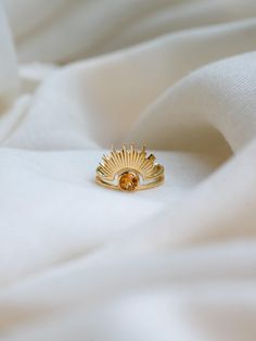 C E L E S T I A L ∙ C I T R I N E ∙ R I N G  Find the matching pendant at https://www.etsy.com/listing/1803089707/celestial-citrine-necklace-24k-gold The ring is crafted with 24k gold vermeil over 925 sterling silver. At its centre, a stunning round-cut citrine gemstone radiates warmth and light, surrounded by a unique sunrise-inspired design that symbolizes new beginnings and positivity. The intricate detailing of the sun rays adds a touch of elegance, making this ring a perfect statement piece Celestial Gold Rings With Gemstone, Gold Celestial Rings With Gemstone, Gold Rings With Topaz Birthstone, Unique Gold Jewelry With Halo Detail, Unique Gold Rings With Birthstone, Unique Gold Halo Jewelry, Unique Gold Halo Rings, Gold Citrine Open Ring Jewelry, Handmade Celestial Yellow Gold Rings